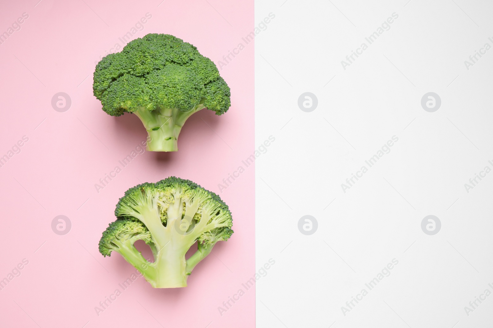 Photo of Fresh tasty broccoli on color background, flat lay. Space for text