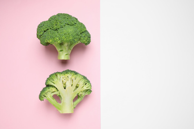 Fresh tasty broccoli on color background, flat lay. Space for text