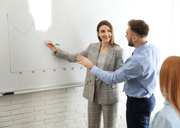 Photo of Professional business trainer working with people in office