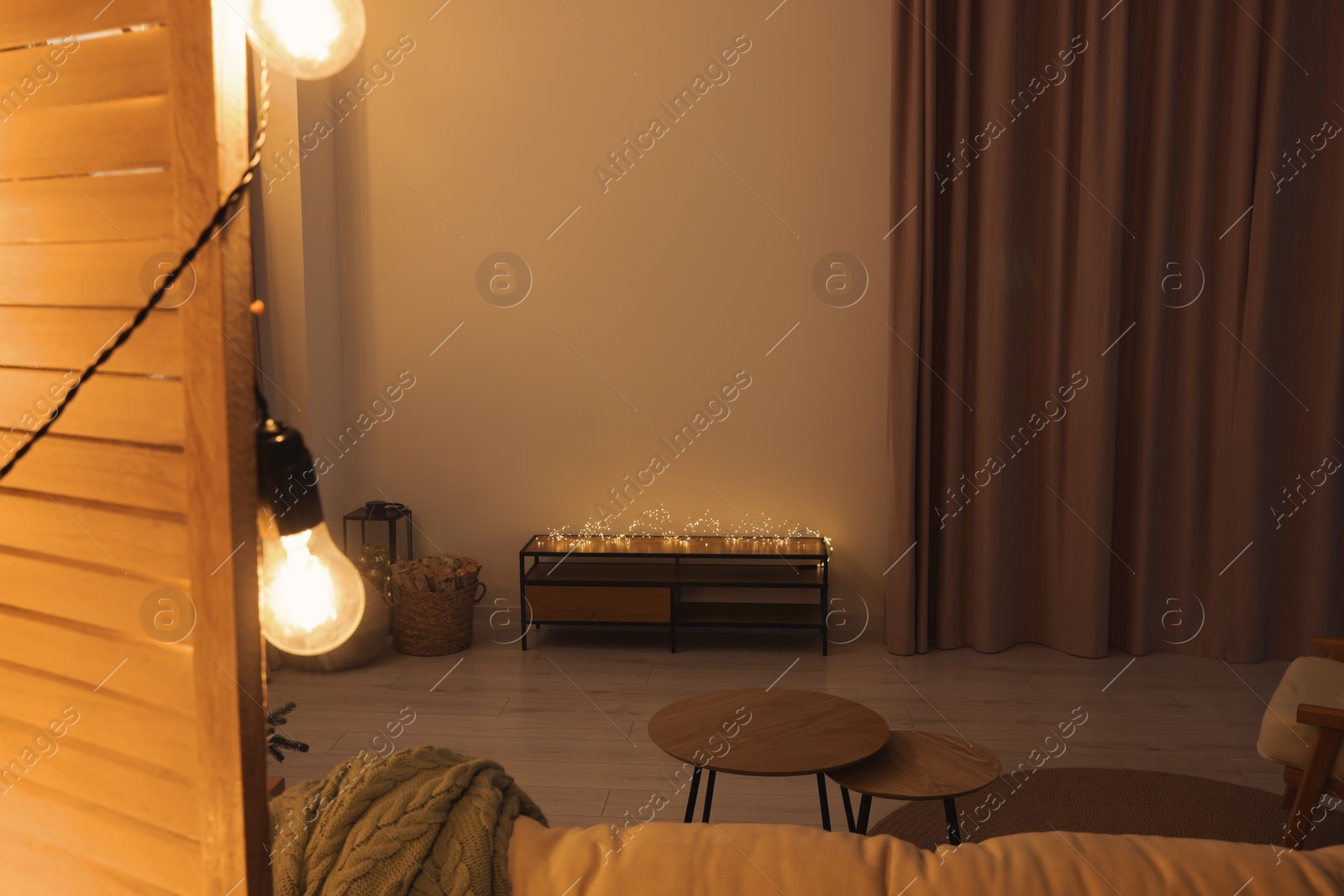 Photo of Tv area with cabinet, stool, coffee table and Christmas decorations in spacious room