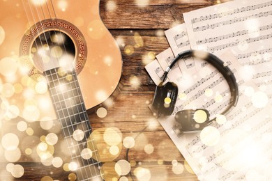 Christmas and New Year music. Headphones and different musical instruments on wooden background, bokeh effect