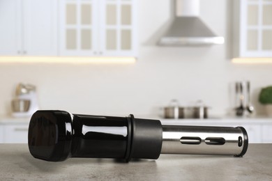 Image of Sous vide cooker on light grey table in kitchen, space for text. Thermal immersion circulator