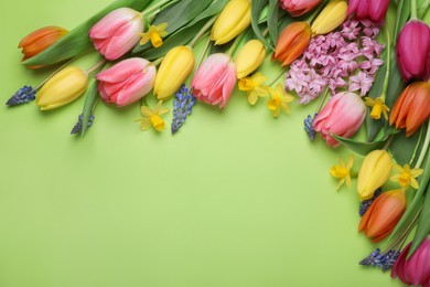 Beautiful different flowers on green background, flat lay. Space for text