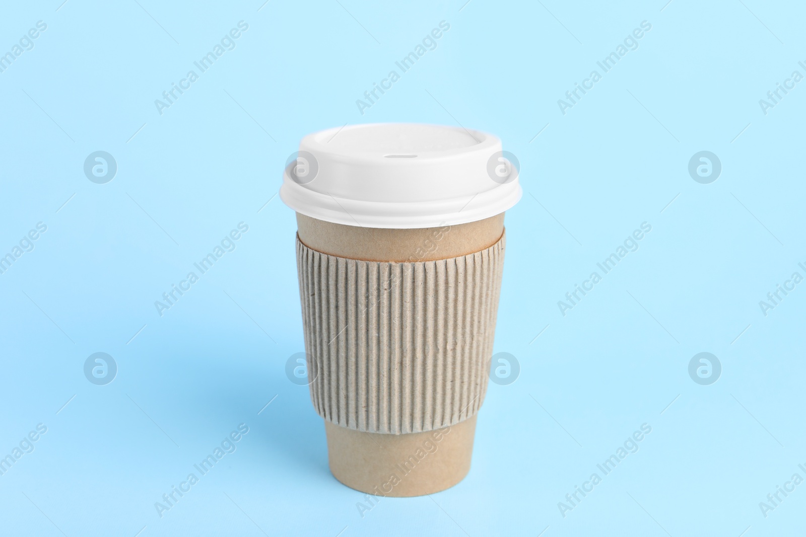 Photo of Paper cup with plastic lid on light blue background. Coffee to go