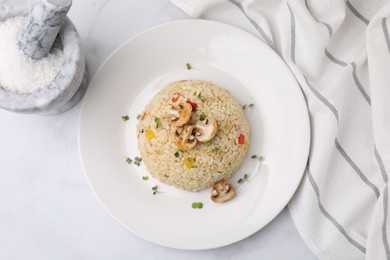 Photo of Delicious bulgur with vegetables, mushrooms and salt on table, flat lay