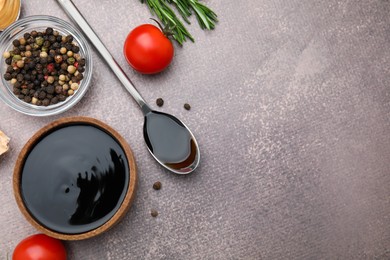 Organic balsamic vinegar and cooking ingredients on grey table, flat lay. Space for text