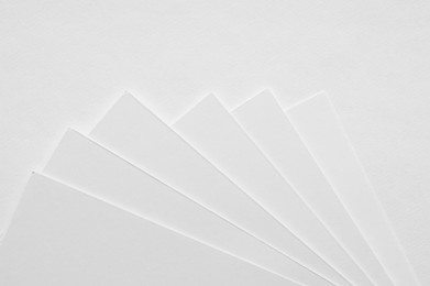 Photo of Blank watercolor paper sheets on white background, flat lay