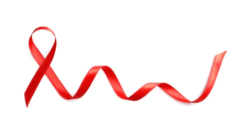 Photo of Red ribbon on white background, top view. Cancer awareness