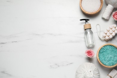 Photo of Flat lay composition of herbal bags and spa products on white marble table. Space for text