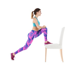 Photo of Young woman exercising with chair on white background. Home fitness