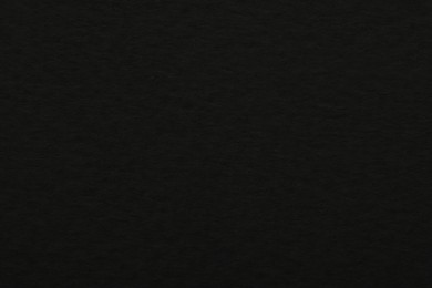 Photo of Texture of black paper sheet as background, top view