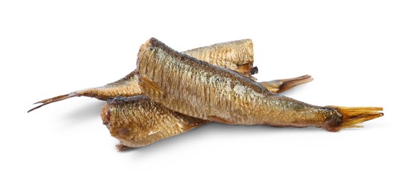 Photo of Many tasty smoked sprats isolated on white