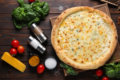 Photo of Flat lay composition with delicious cheese pizza and ingredients on wooden table