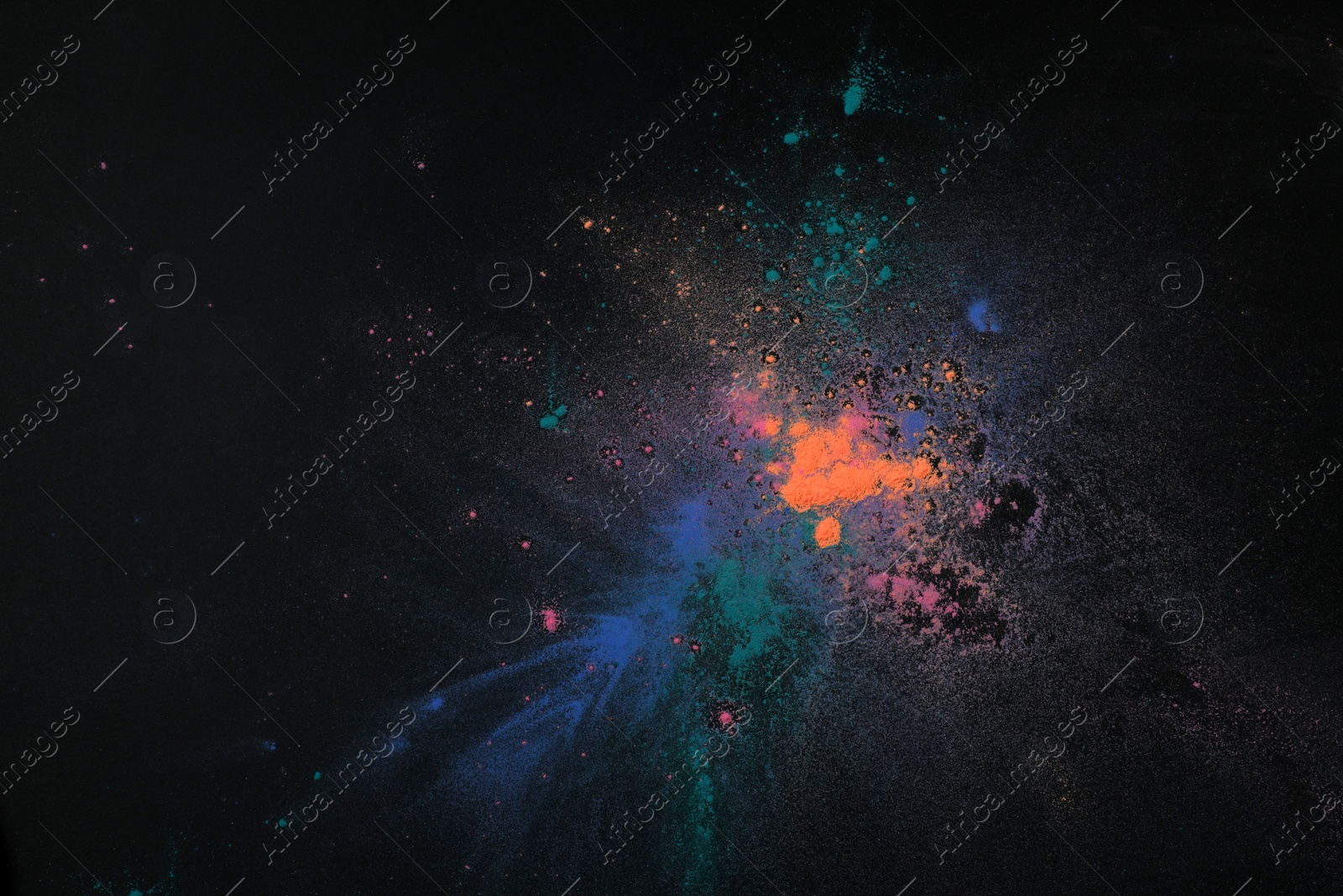 Photo of Colorful powder dyes on dark background, top view. Holi festival