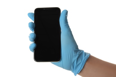 Photo of Person in blue latex gloves holding smartphone with blank screen against white background, closeup on hand. Space for design