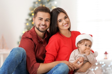 Photo of Happy family with cute baby at home. Christmas celebration