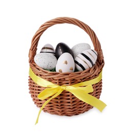 Photo of Wicker basket with beautifully painted Easter eggs isolated on white