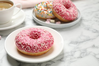Photo of Yummy donut with sprinkles on white marble table