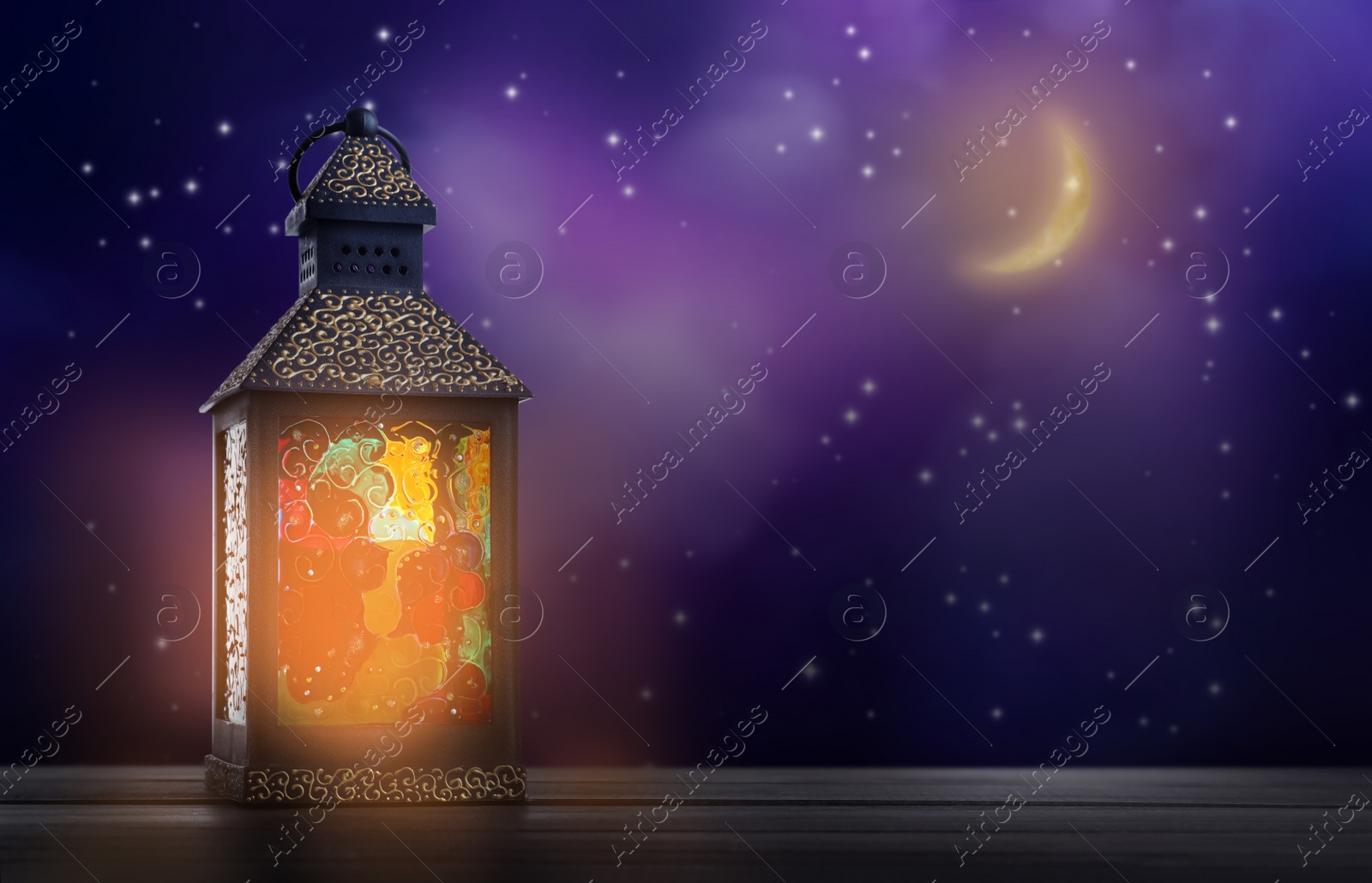 Image of Beautiful decorative Arabic lantern on wooden table at night, space for text. Fanous as Ramadan symbol