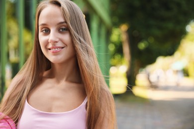 Photo of Portrait of beautiful young woman outdoors, space for text