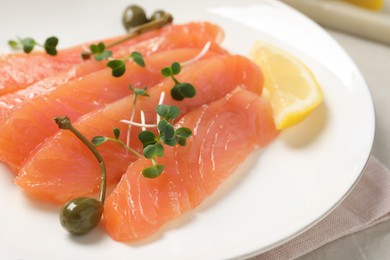 Photo of Delicious salmon carpaccio served on table, closeup