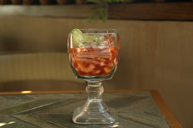 Photo of Delicious campechana cocktail with fresh ingredients on table