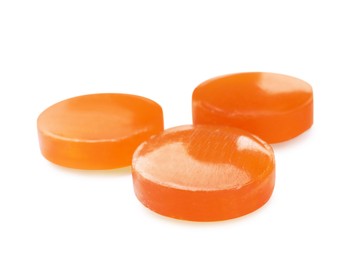 Photo of Orange cough drops on white background. Pharmaceutical product