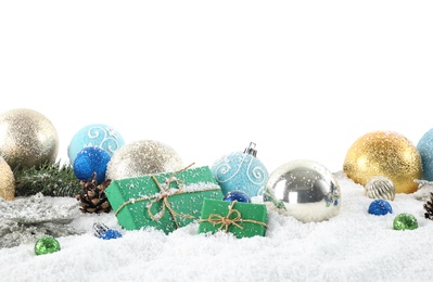 Photo of Fir branches, Christmas decoration and snow against white background