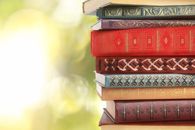Image of Collection of different books on blurred background, space for text