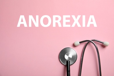 Image of Anorexia concept. Stethoscope on pink background, top view
