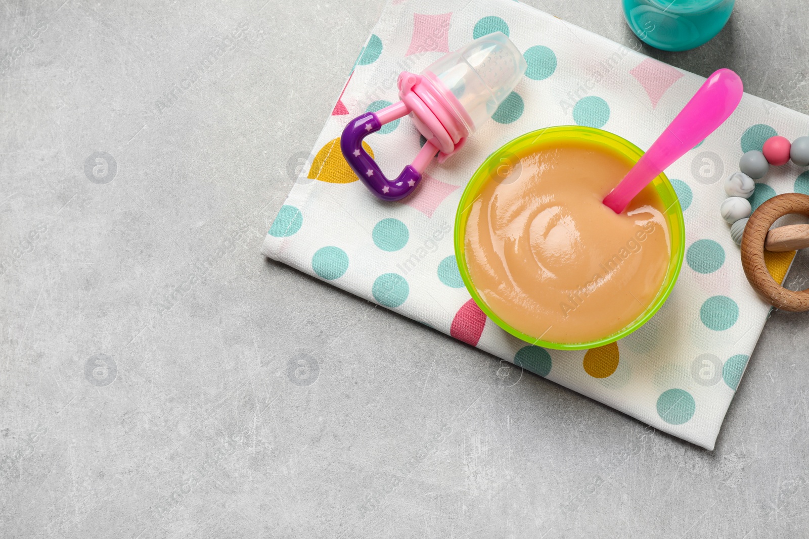 Photo of Flat lay composition with healthy baby food on grey table, space for text