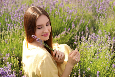 Photo of Young woman in lavender field on summer day