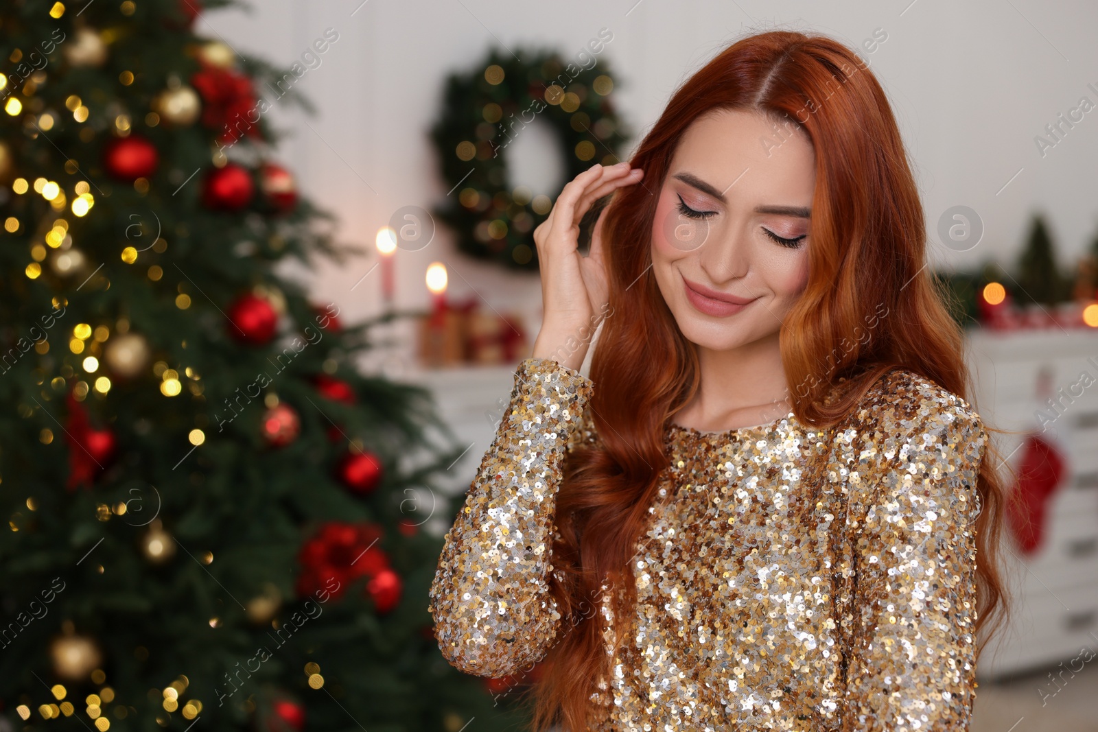 Photo of Beautiful young woman in room decorated for Christmas