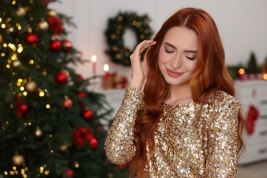 Photo of Beautiful young woman in room decorated for Christmas