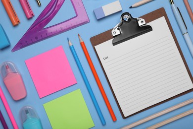 Photo of Flat lay composition with different school stationery on light blue background, space for text. Back to school