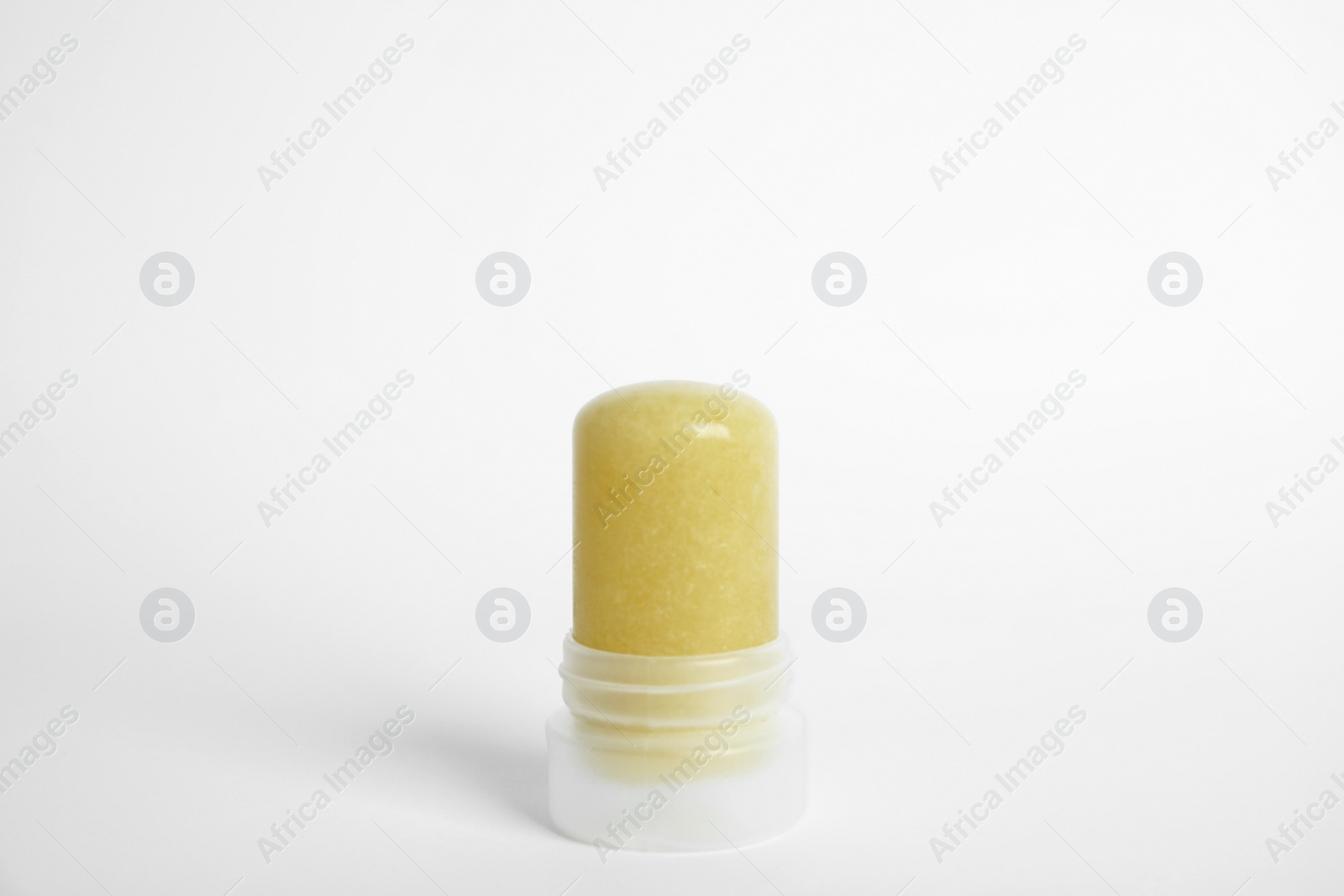 Photo of Natural crystal alum stick deodorant on white background