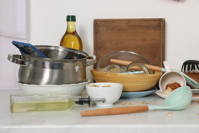 Photo of Messy countertop with many dirty utensils, dishware and food leftovers in kitchen