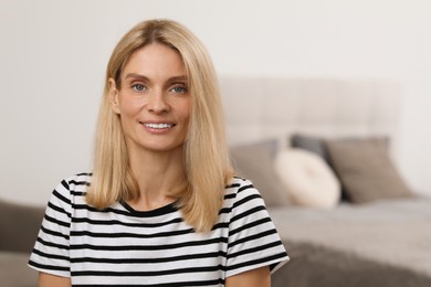 Photo of Portrait of beautiful woman with blonde hair. Attractive lady smiling and looking into camera. Space for text
