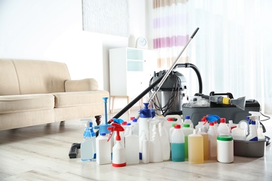Photo of Professional cleaning supplies and equipment on floor indoors. Space for text