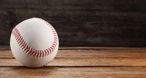 Photo of Baseball ball on wooden background, space for text
