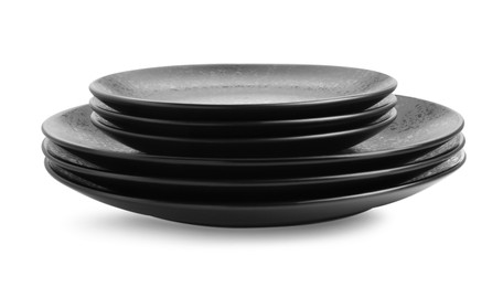 Photo of Stack of black ceramic plates isolated on white