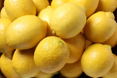 Photo of Many fresh lemons as background, top view