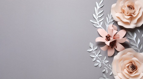 Photo of Different beautiful flowers and branches made of paper on grey background, flat lay. Space for text