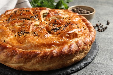Photo of Tasty homemade pie with filling on grey table