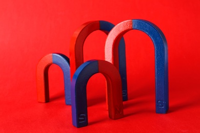 Photo of Red and blue horseshoe magnets on color background