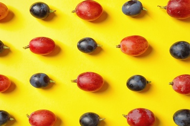Photo of Fresh ripe juicy grapes on yellow background, top view