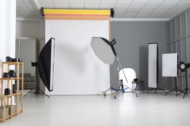 Photo of White photo background and professional lighting equipment in studio
