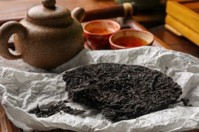 Photo of Broken disc shaped pu-erh tea and on table