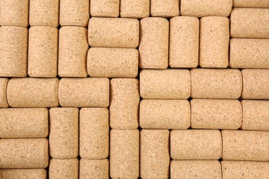 Photo of Many wine bottle corks as background, top view