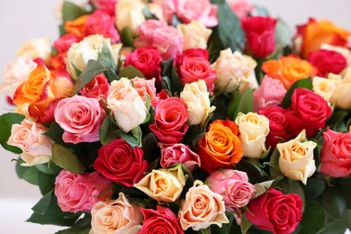 Photo of Bouquet of beautiful roses on light grey background, closeup